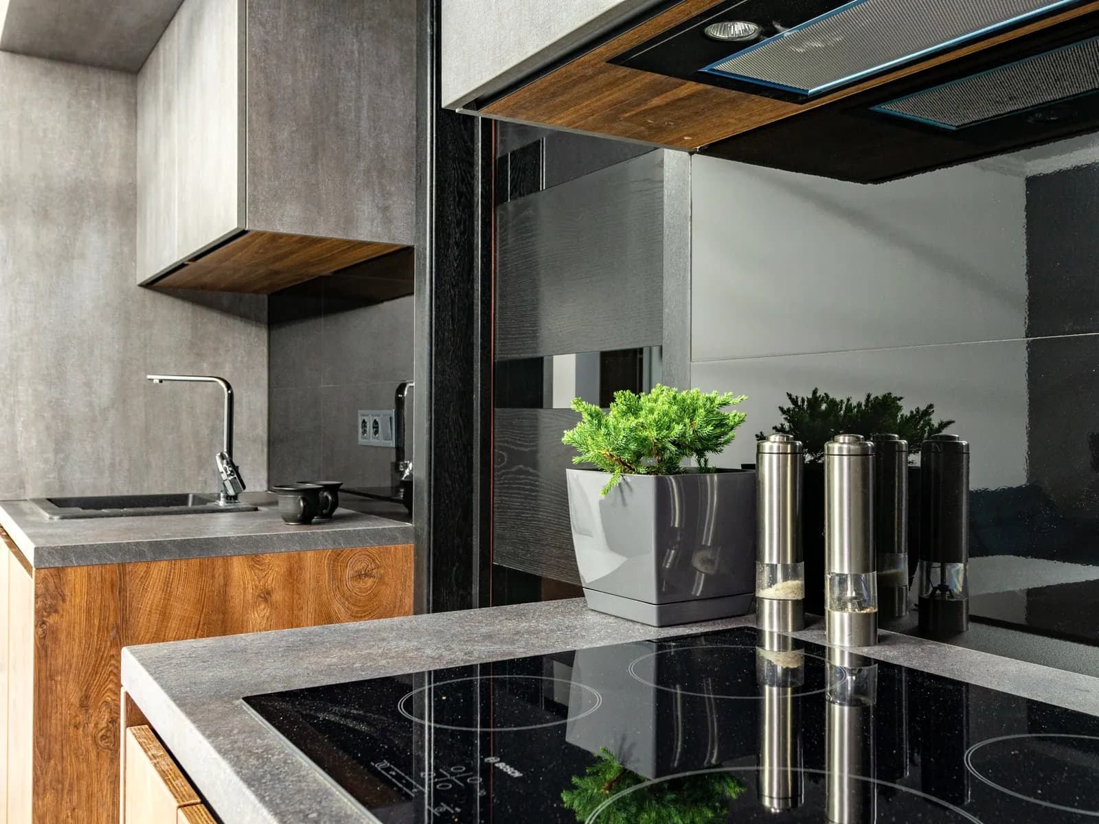 Induction cooktop set into a stone counter in a modern kitchen