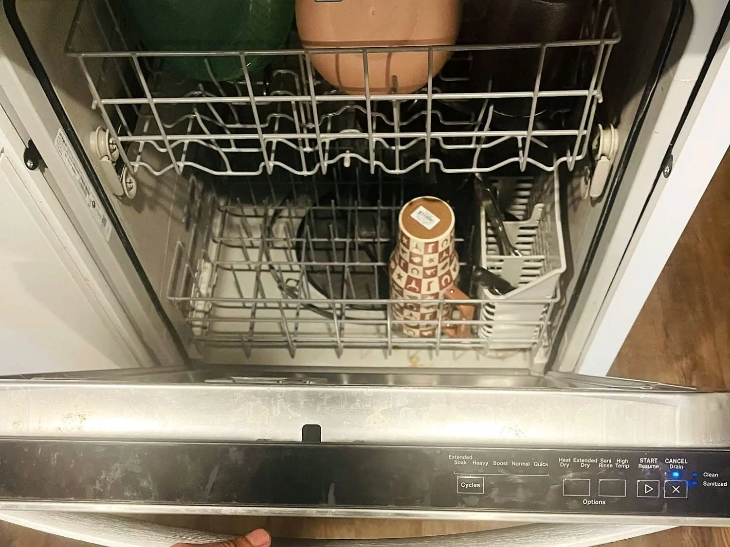 Built-in dishwasher with the door down, both racks and the control panel visible