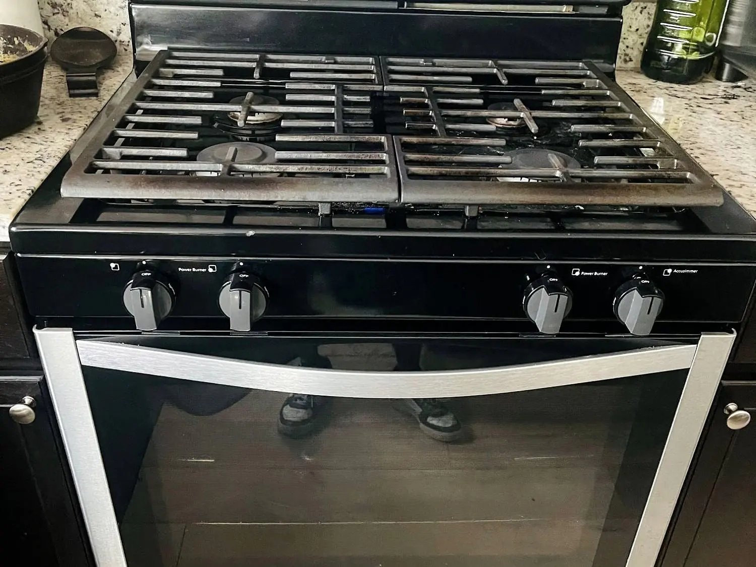 Whirlpool five-burner gas range with cast-iron grates and a black oven door