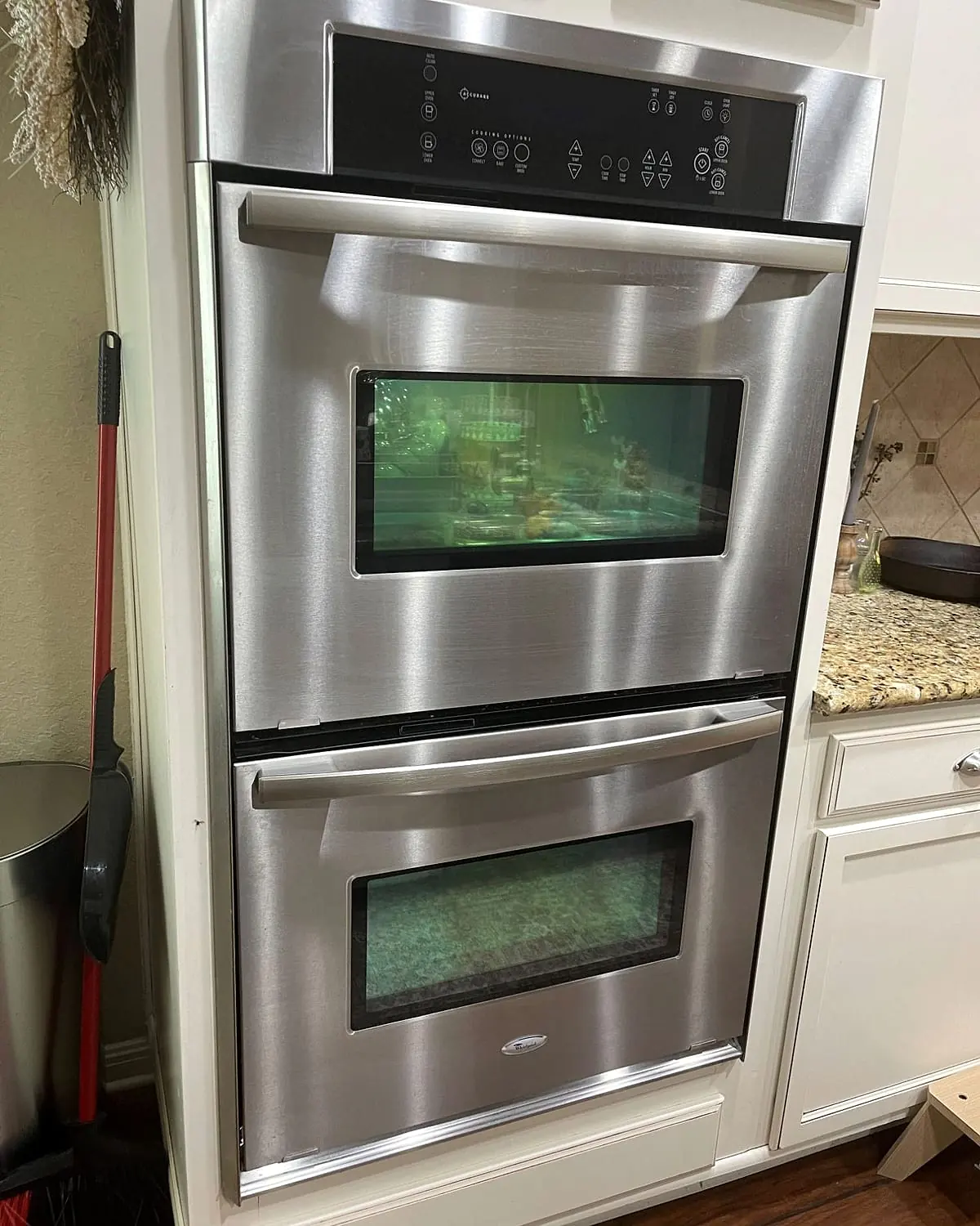 Stainless steel Whirlpool double wall oven set into white cabinets